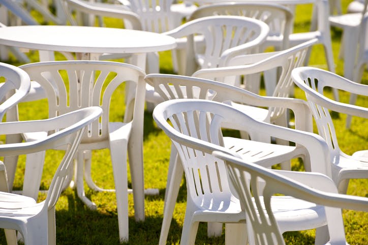 Varias sillas de plástico en un jardín.