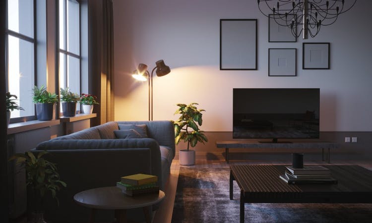 Detalle de una lámpara junto a un sofá en un salón